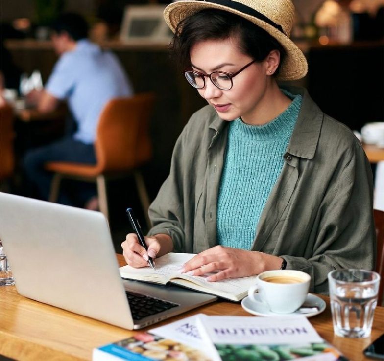 author researching nutrition books at a cafe